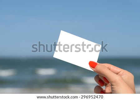Girl Hand Holding Blank White Card On Beach In Summer