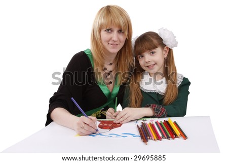 Mother and her young daughter drawing together, set of felt tips on the table. Schoolgirl is drawing  in pencil. Woman is painting the picture. Isolated over white background.