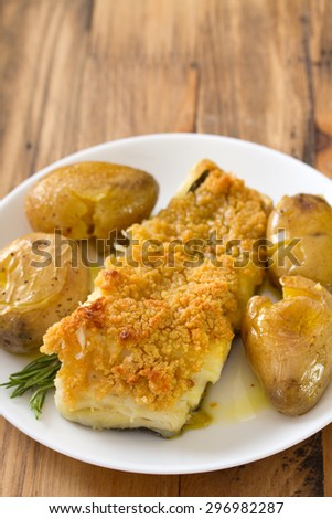 fried cod fish with bread and potato on dish