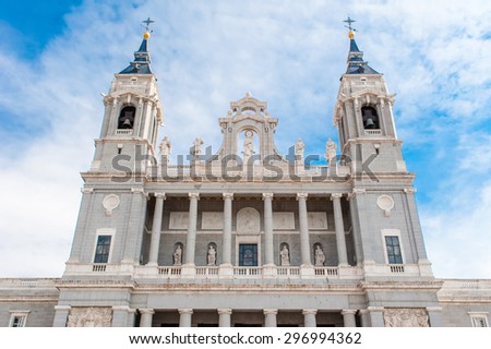 Cathedral of Saint Mary the Royal of La Almudena on the blue sky background with white clouds in Madrid, Spain. Madrid is a popular tourist destination of Europe.