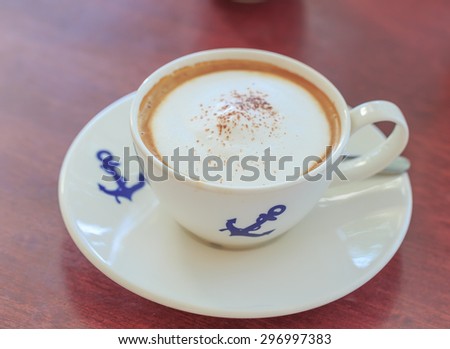 hot cappuccino in white cup and anchor picture 
