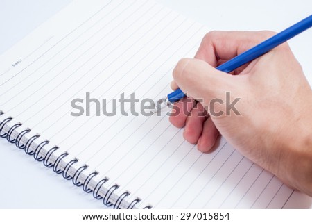 Hand with pencil writing something isolated on white background with shadows