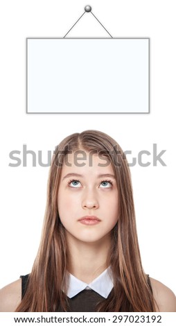 Young teenage girl looking up on empty picture frame isolated on white background