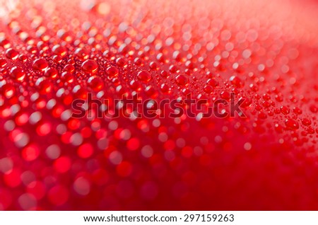 water drops on red background - selective focus