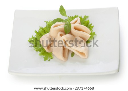 Some squid rings with fresh green lettuce and basil on the white plate