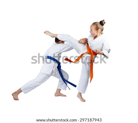 Ura mavashi geri and gyaku tsuki are beating sportsmens in karategi Royalty-Free Stock Photo #297187943
