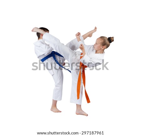 Mae geri and ura-mavashi geri are beating sportsmens in karategi Royalty-Free Stock Photo #297187961