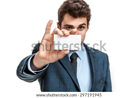 Business man in suit showing his blank business card ready for your text / photos of young businessman wearing  a suit and tie over white background