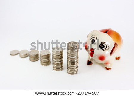 piggy bank and coins on white background