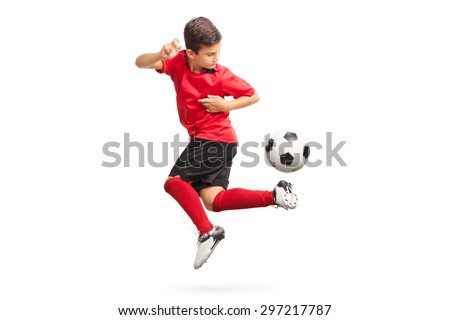 Studio shot of a junior soccer player performing a trick with a soccer ball isolated on white background