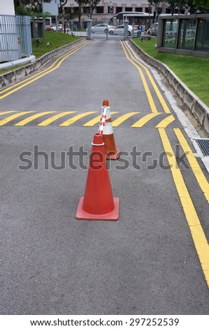 Red cones and yellow striped warning road