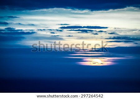 last seconds of a distant sunset over the ocean