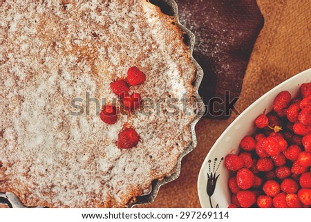 Fresh homemade pastries, charlotte with strawberries sprinkled with icing sugar, tasty and easy to prepare lesert
