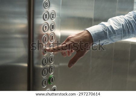Pressing the button in the elevator Royalty-Free Stock Photo #297270614