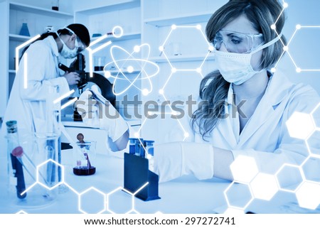 Science graphic against two female scientists conducting an experiment