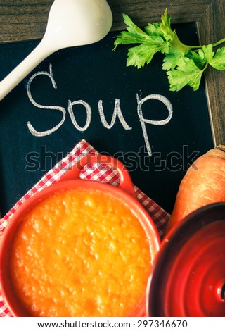 Different kinds of soups - sprinach soup, french onion cream-soup and carrot cream-soup on the table. Toned image.