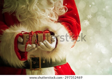 Santa Claus gloved hands holding giftbox