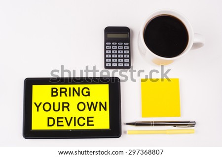 Business Term / Business Phrase on Tablet PC with a cup of coffee, Pens, Calculator, and yellow note pad on a White Background - Black Word(s) on a yellow background - Bring Your Own Device