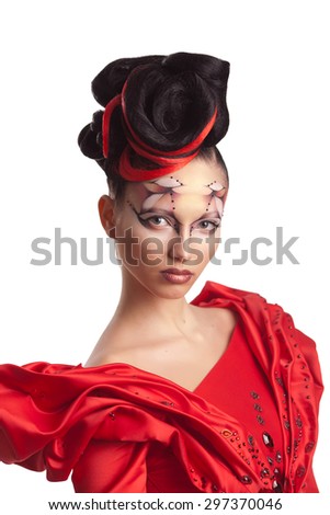 Studio portrait of a brunette with make-up in the style of body art, scarlet dress and hair in the form of roses