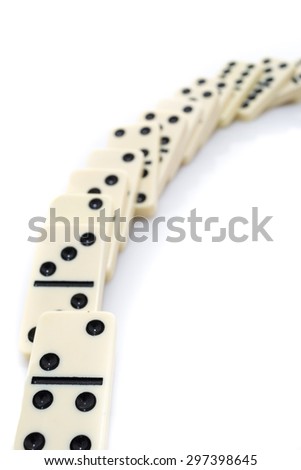 Fallen dominoes over white background