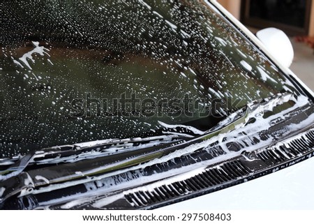 foam on wind shield while car washing Royalty-Free Stock Photo #297508403
