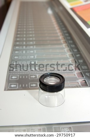 Test lens on the electronic control panel of offset machine