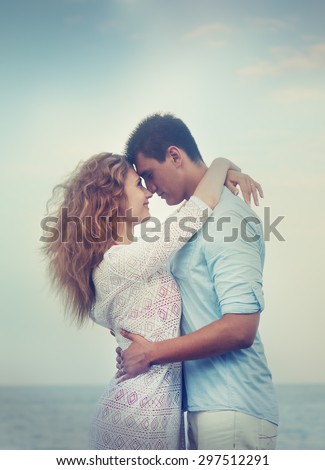 lovely young couple on the beach, image with retro toning and soft focus