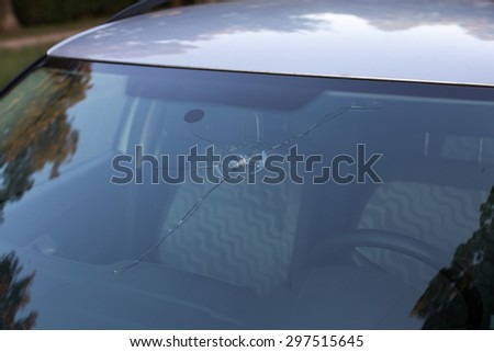 Smashed windscreen of a car, damaged glass Royalty-Free Stock Photo #297515645