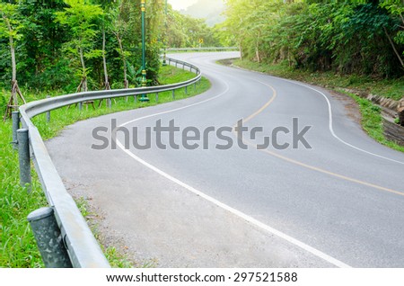 Road on mountain in country, S-shape.