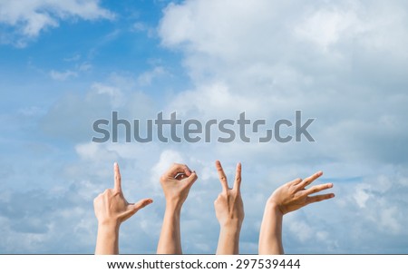 Alphabet Love Hands symbols in front of blue Sky