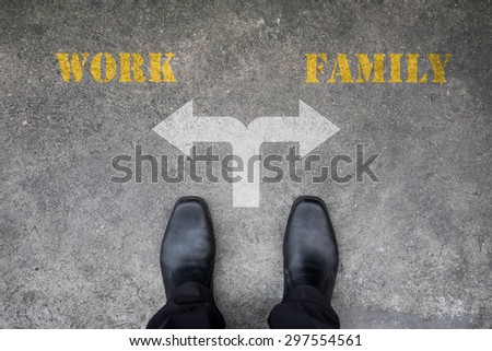 Businessman making decision at the crossroad - work or family