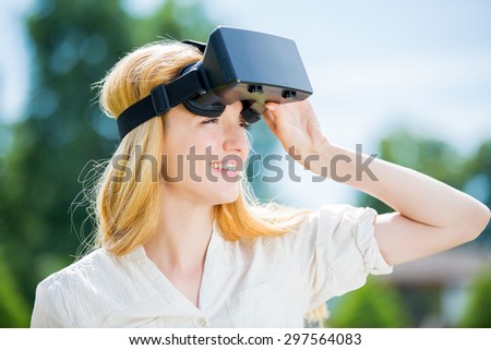 Girl uses head-mounted display in park
