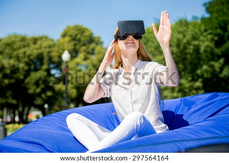 Girl uses head-mounted display in park
