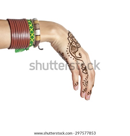 Mehendi or henna tatoo on the female hands in bracelets isolated on white