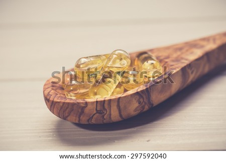 Fish oil capsules in a spoon 