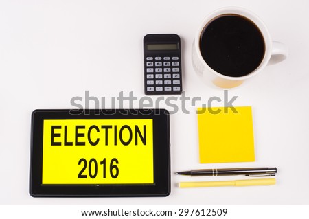 Business Term / Business Phrase on Tablet PC with a cup of coffee, Pens, Calculator, and yellow note pad on a White Background - Black Word(s) on a yellow background - Election 2016