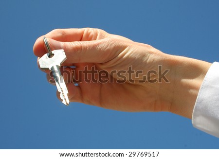  key in a palm over blue background
