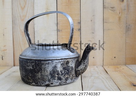 Classic kettle for camping on wood board