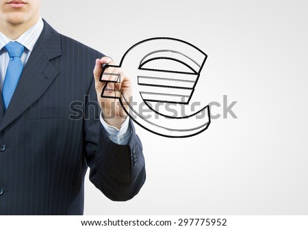 Close up of businessman drawing euro symbol with marker
