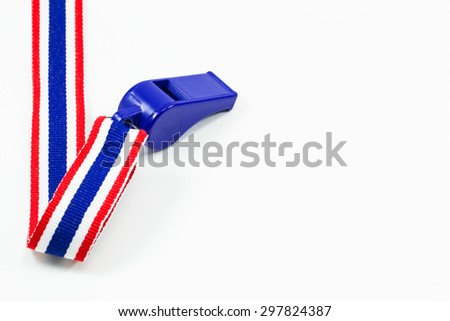 Blue whistle with red blue white cloth ribbon isolated on white background