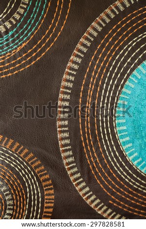 Circle stitch design on brown leather
