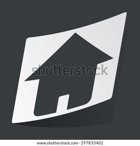 White sticker with black image of house, on black background