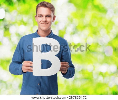 happy young man with b letter