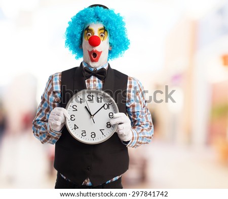 portrait of a funny clown holding a clock