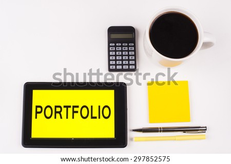 Business Term / Business Phrase on Tablet PC with a cup of coffee, Pens, Calculator, and yellow note pad on a White Background - Black Word(s) on a yellow background - Portfolio
