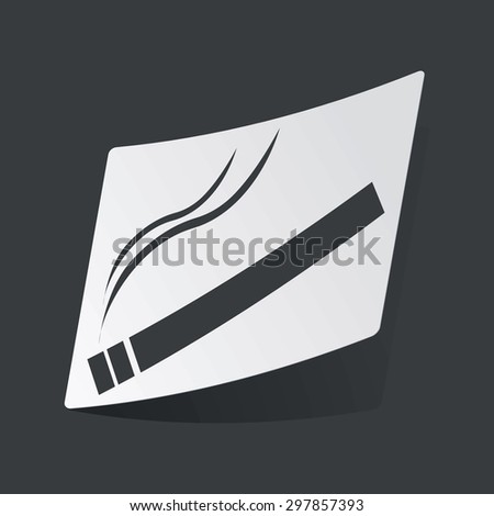 White sticker with black image of burning cigarette, on black background