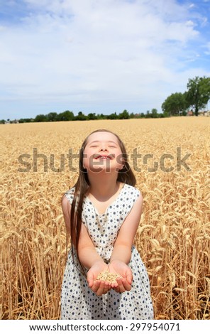 Young girl have fun in the wheat field