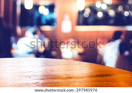 Empty round table top at coffee shop blurred background with bokeh light,Template mock up for display of your product