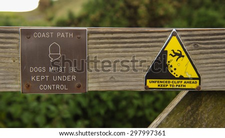 "Coast Path, Dogs must be Kept Under Control, Unfenced Cliff Ahead Keep to Path" Sign in Devon,England,UK