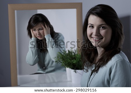 Smiling pretty young girl with bipolar disorder Royalty-Free Stock Photo #298029116
